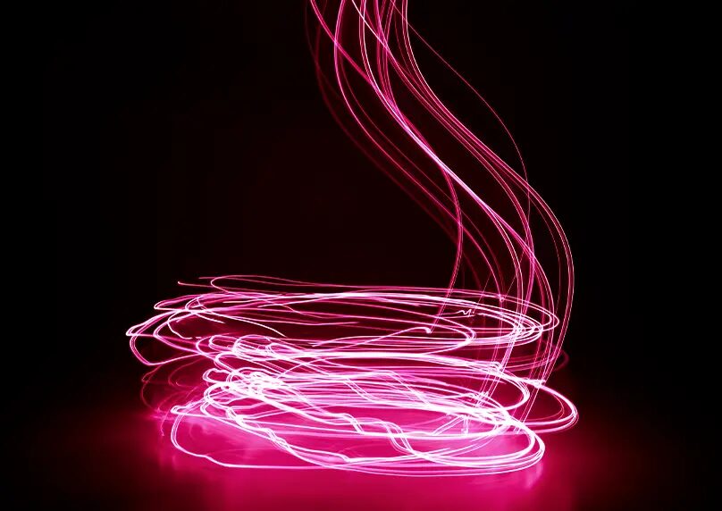 Motion blur of light making circular pattern on pink surface