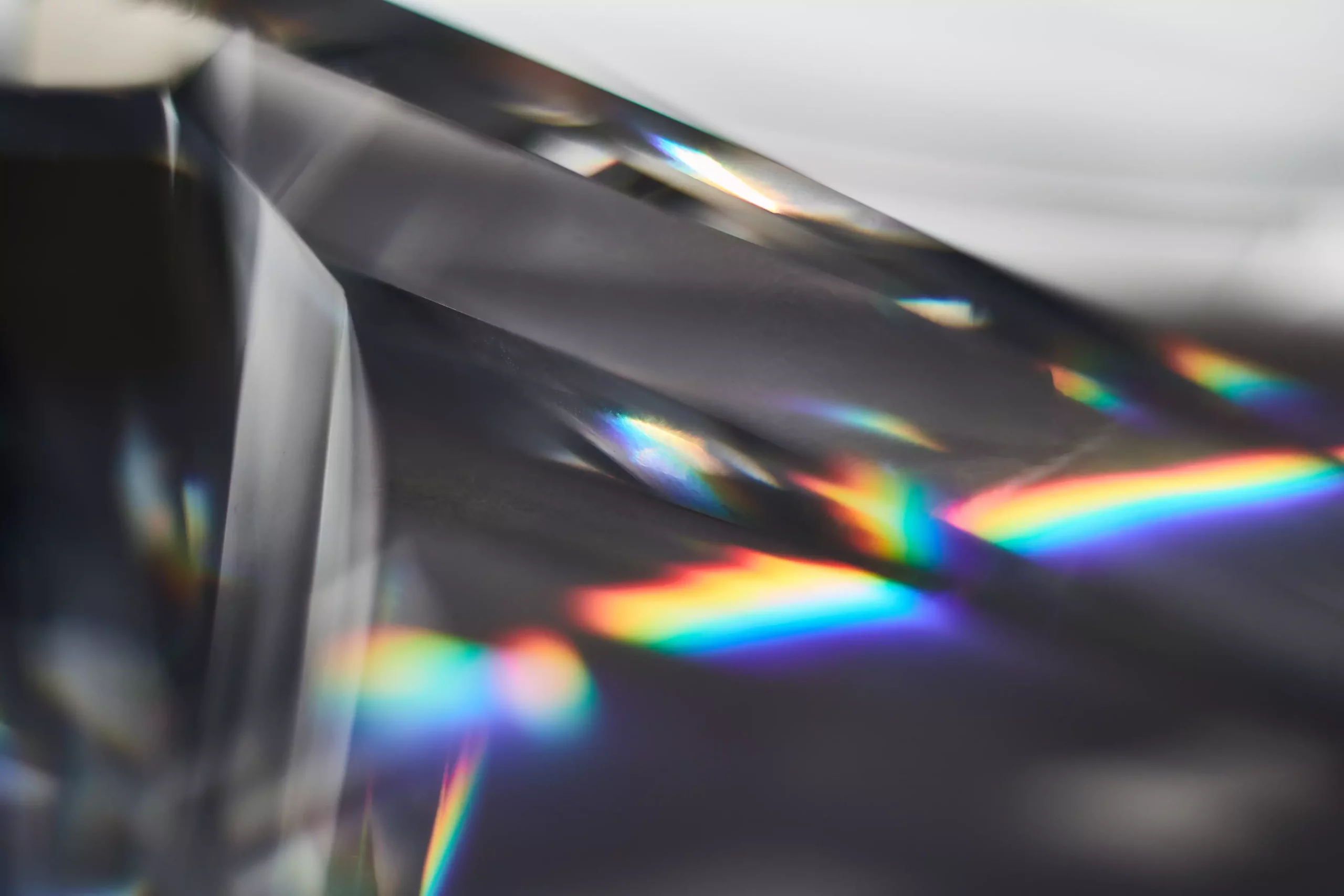 Macro view of a prism dispersing sunlight splitting into a spectrum